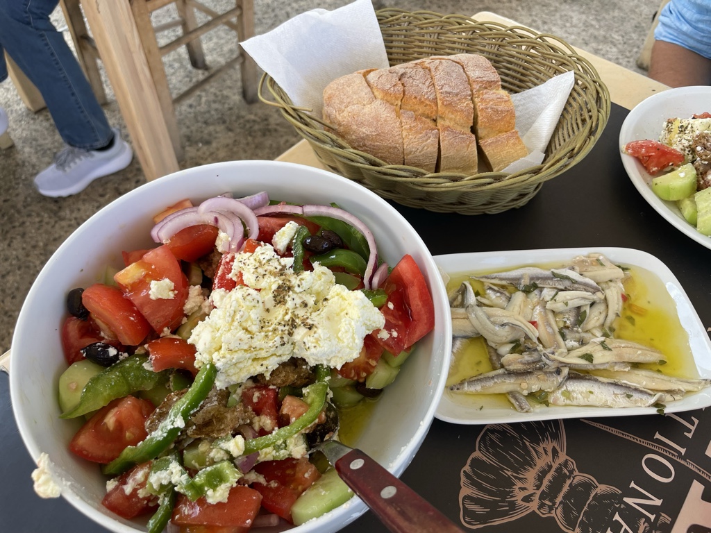 Anchovies plus a massive horiatiki! The cheese is mizithra instead of feta, a Cretan convention.