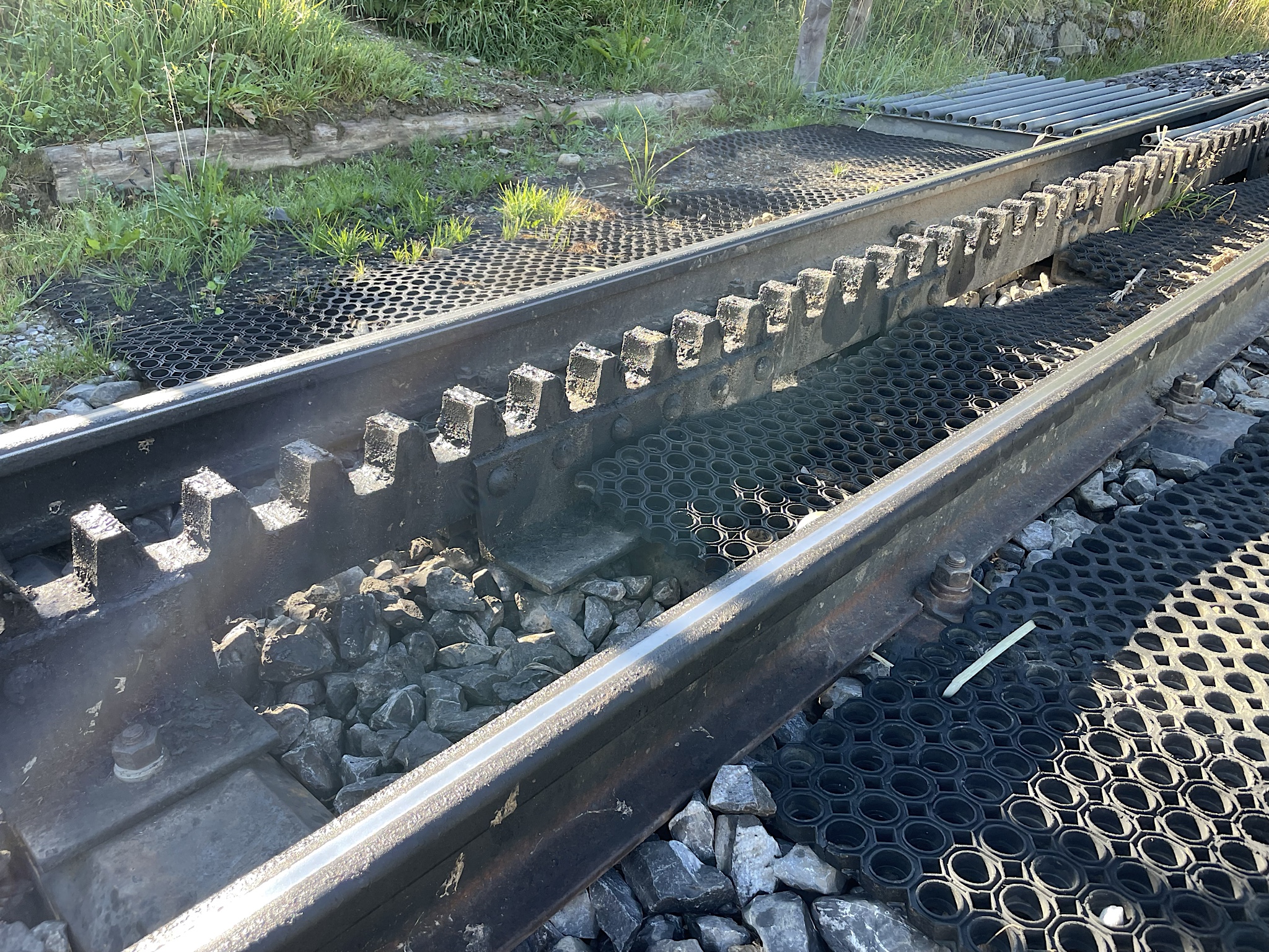 Cog railroads use gears on these cogs to prevent runaway trains on steep terrain. They’re a step below funiculars, which have cables in addition to cogs and are used on steeper terrain.