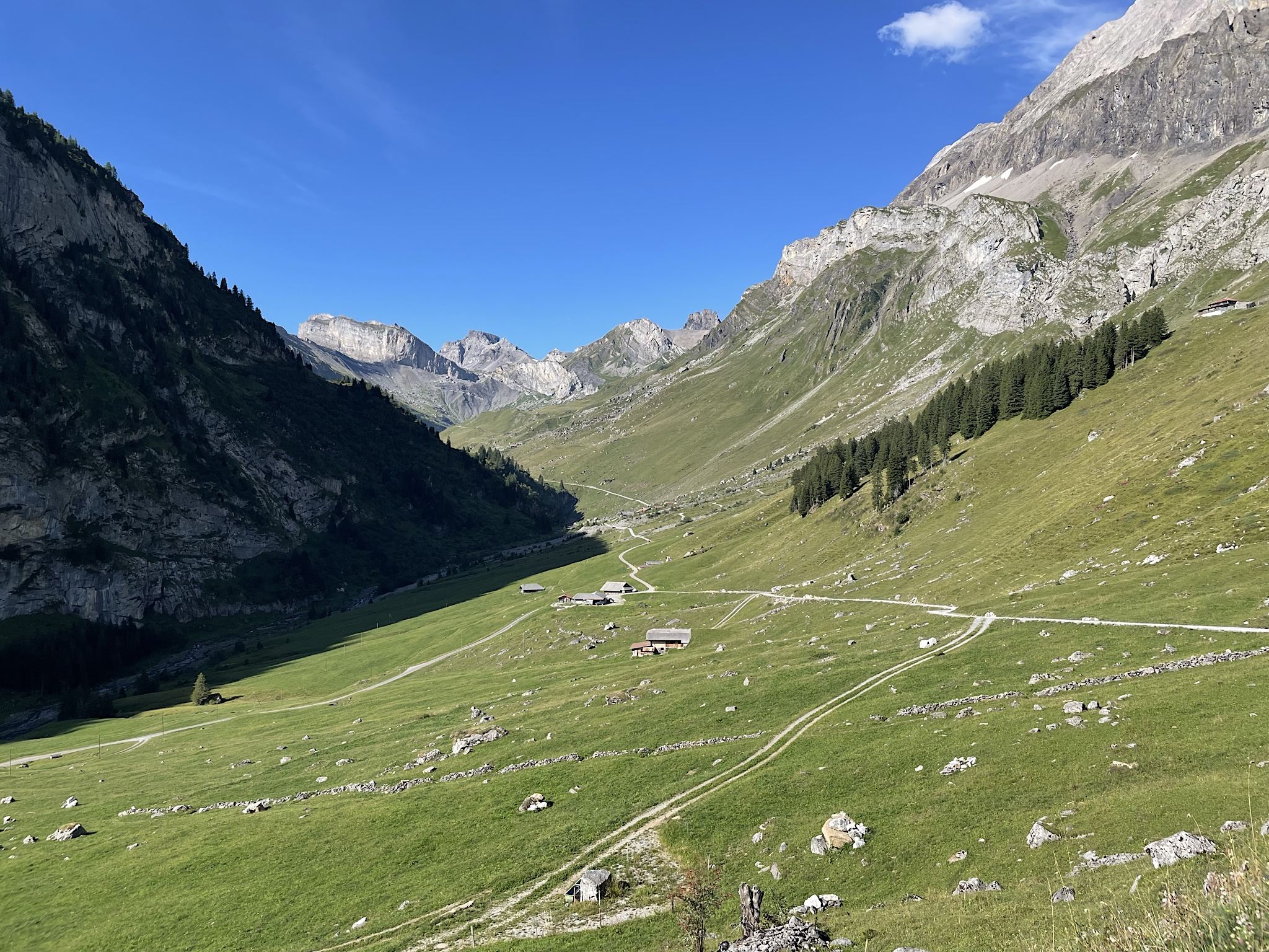 I believe this is Usser Uschine? The trail follows that dirt road down the middle of the valley and then turns sharply upward on the other side of those trees.