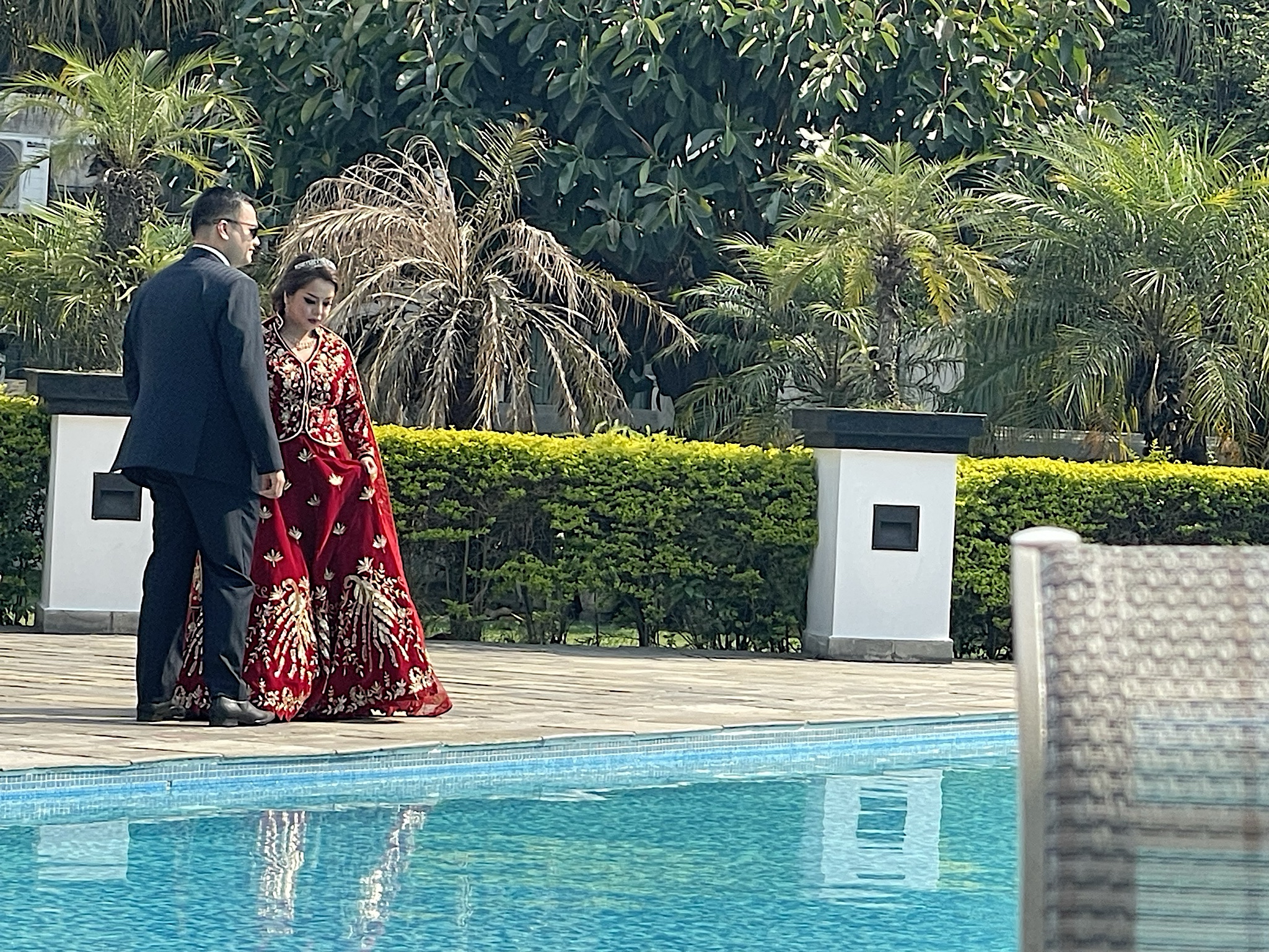 This wedding couple was doing a photo shoot by the pool.