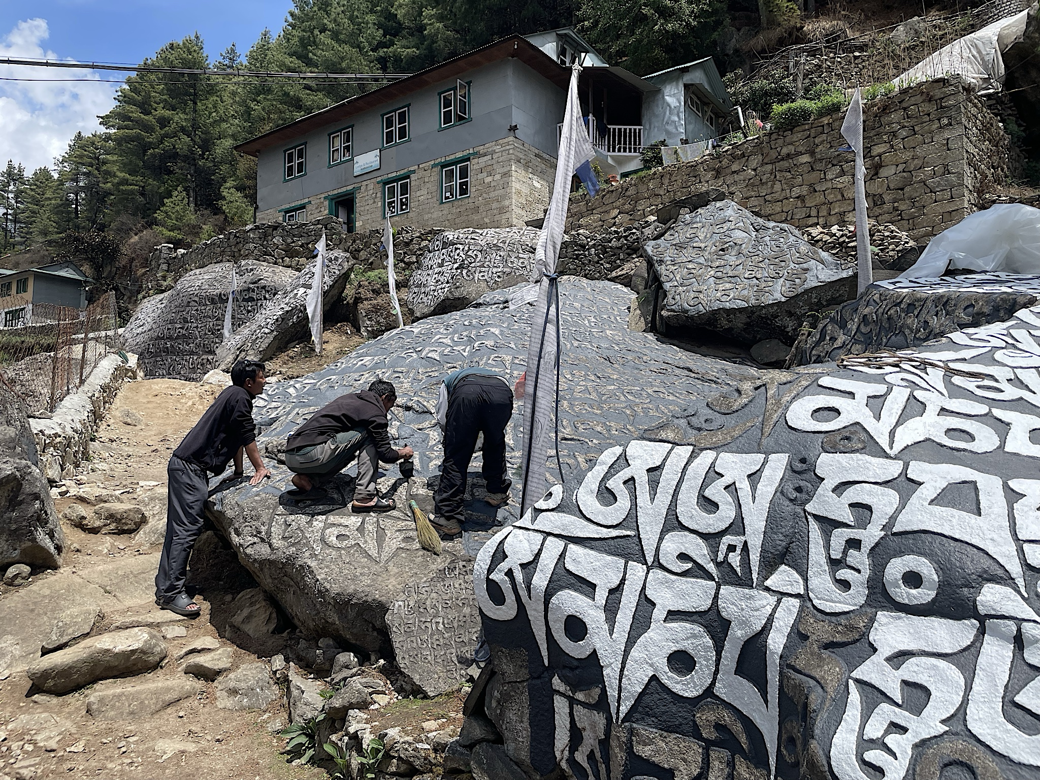 These monks were painting the mantra stone just outside the lodge. They were just finishing it up when we returned over a week later.